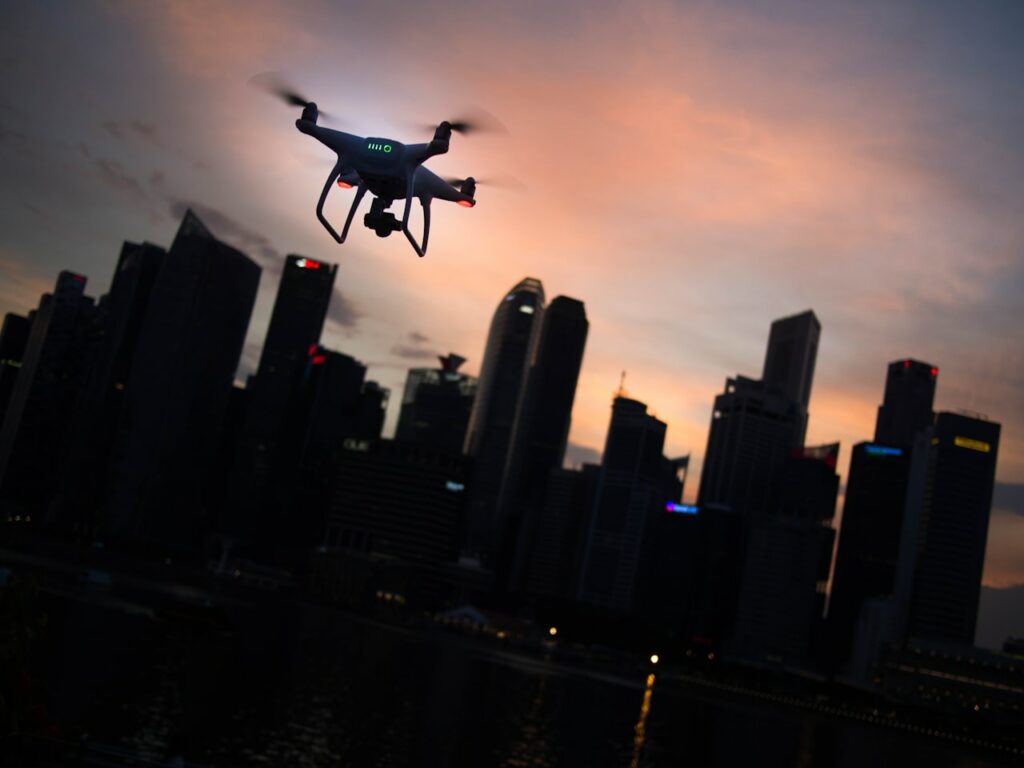 Silhouette of a drone flying over the city, illustrating various drone flight scenarios