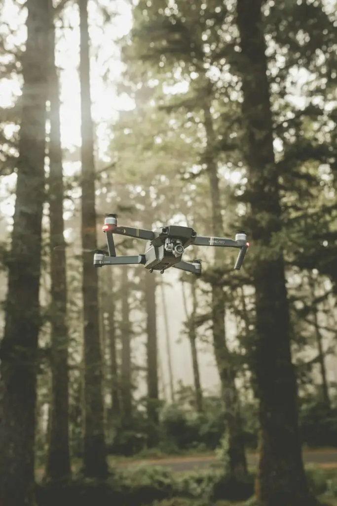 DJI Mavic Pro drone flying near a forest illustrating drone market trends
